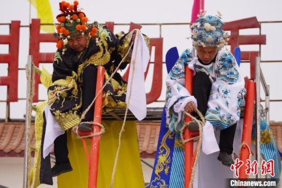 圖為“苦水高高蹺”表演者通過麻繩將腳固定在腳踏板，并在腿部纏繞六七圈?！【琶赖┰?攝