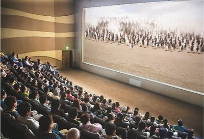 游客在莫高窟數(shù)字展示中心觀看主題電影《千年莫高》。