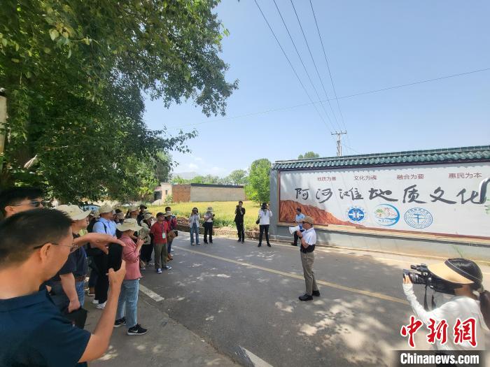 圖為中國(guó)地質(zhì)大學(xué)(北京)教授張緒教介紹村落情況?！『衍?攝