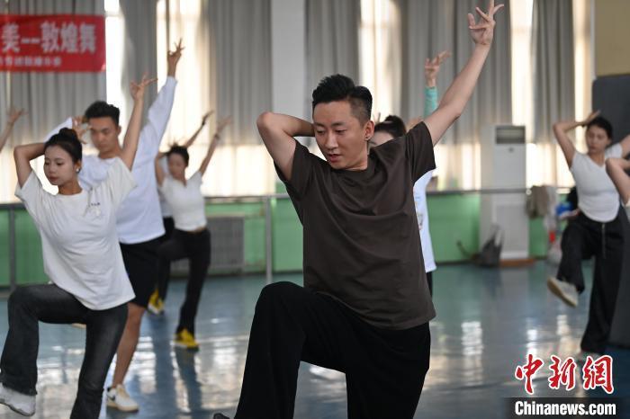 6月6日，在甘肅敦煌青年夜校課程中，青年學(xué)員學(xué)習(xí)敦煌舞課程。李亞龍 攝　　